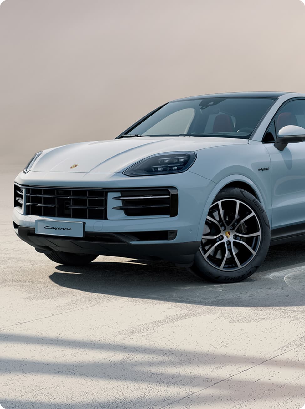 A Porsche Cayenne driving on an open road.